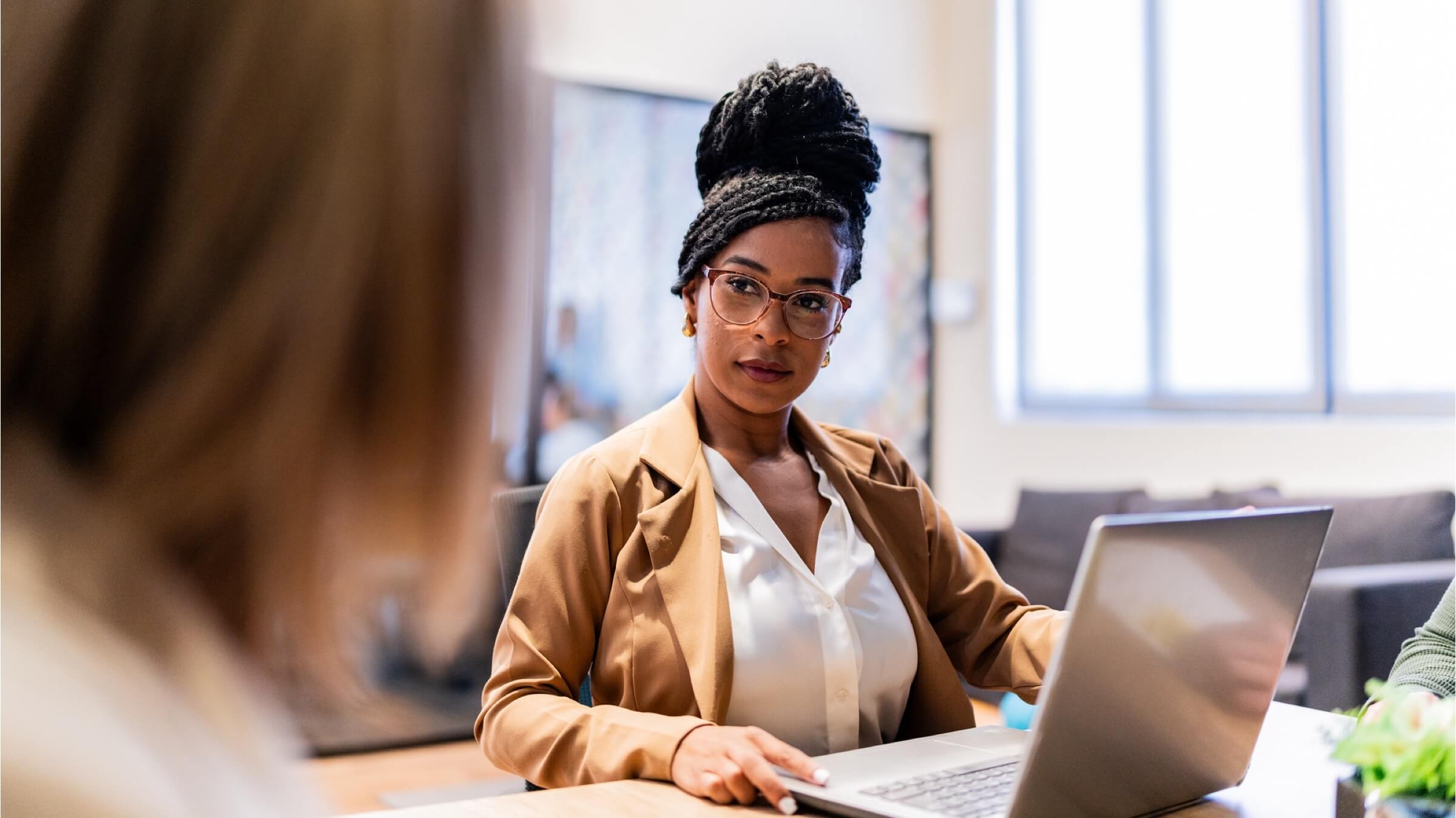 businesswoman intently listening to coworker header