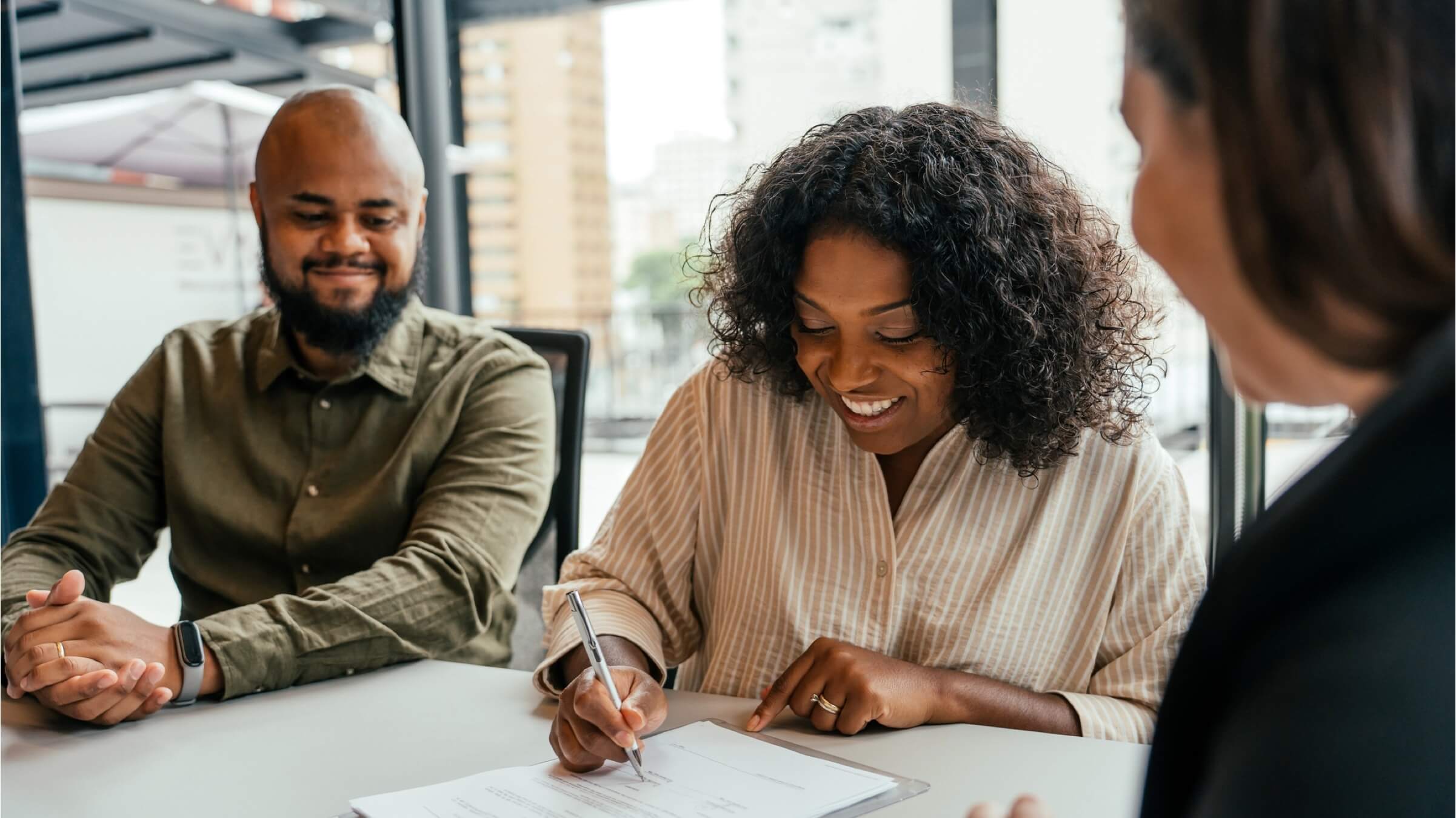 couple signing contract with advisor header