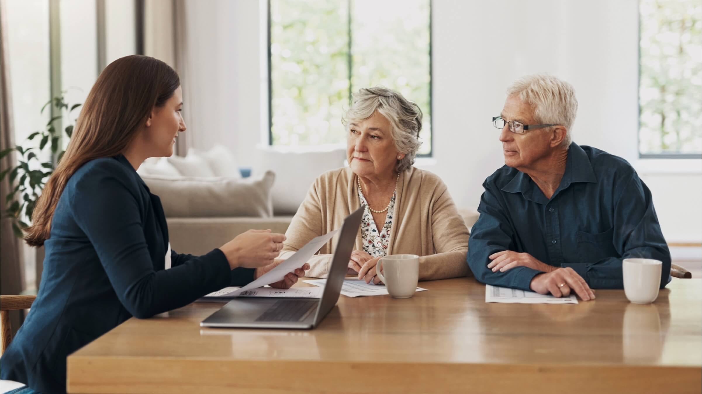 elderly couple talks with financial advisor header