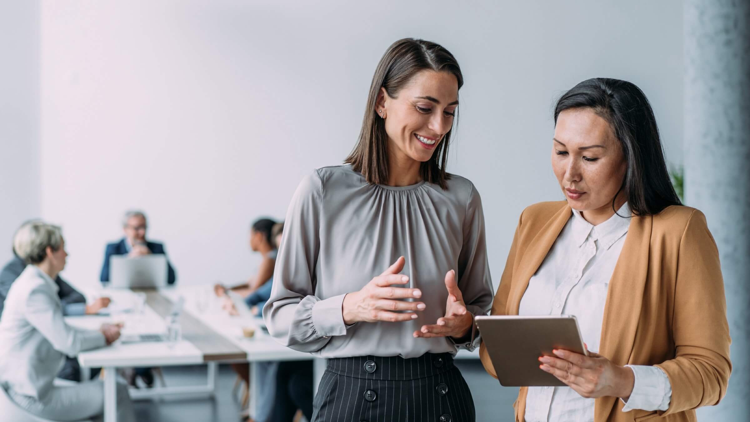 business people discuss in office header@2x