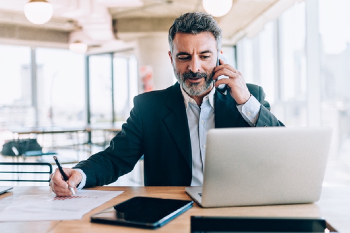 businessman at office talking phone@2x