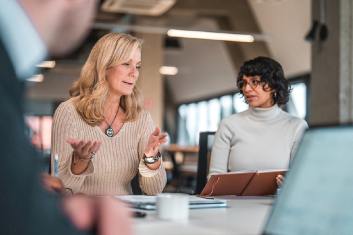 female coworkers discussing ideas@2x