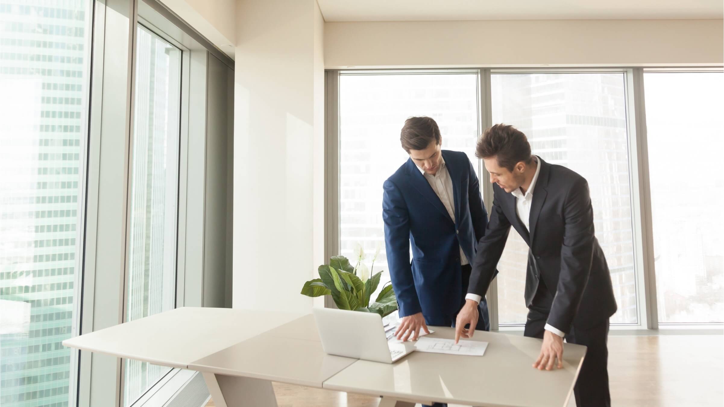 two men reviewing construction plans header two men reviewing construction plans header