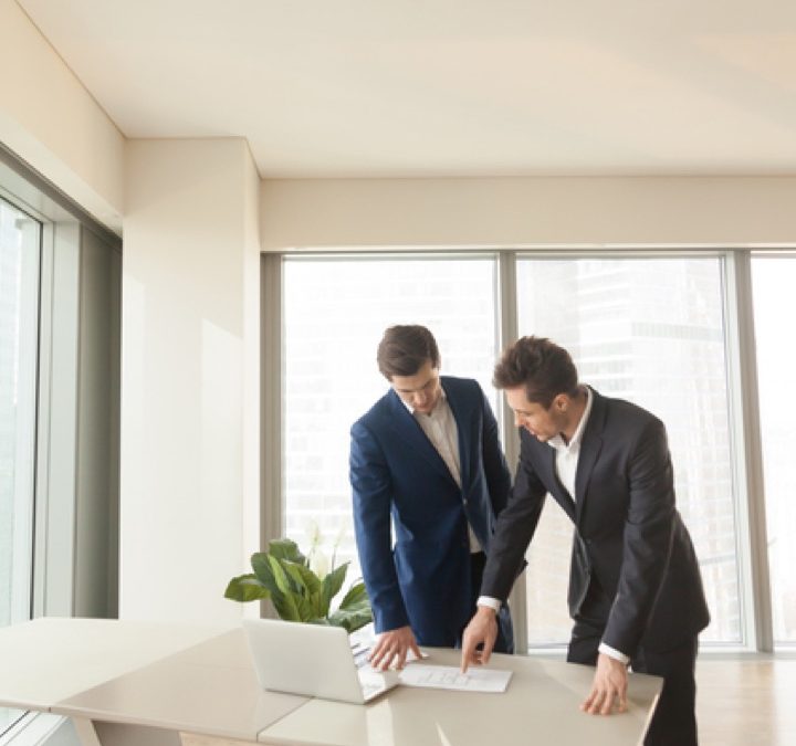 two men reviewing construction plans