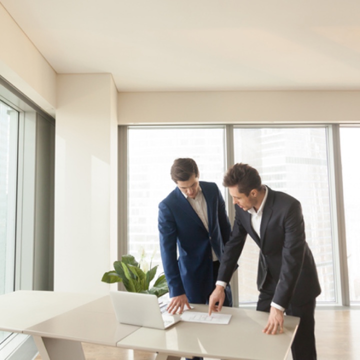 two men reviewing construction plans