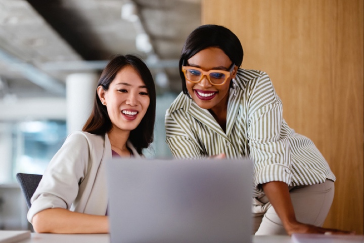 two professional women collaborating@2x